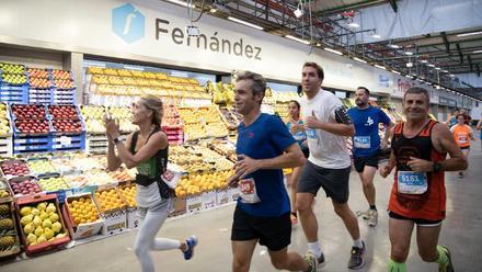 Participantes de la pasada edición de la Cursa Mercabarna corren por el mercado de frutas.